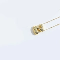 Gold pendant necklace featuring a cubic zirconia-encrusted letter N charm on a white background - Style Z