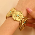 Close-up of a gold boho cuff bracelet with turquoise beads and textured metal discs - Round Pleated Turquoise Embellished (WG-0429)