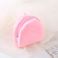Pink plush coin purse with matching zipper on soft white mesh fabric background - Pink