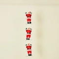 Christmas decoration featuring three Santa Claus figures climbing on a white rope ladder - 25CM Climbing Ladder Santa (Triple)