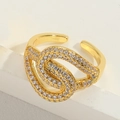 Detailed macro view of vintage golden interlocking ring featuring pavé-set zircon crystals - Adjustable Open / Hollow Style