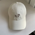 Close-up of brown dachshund puppy embroidery on a beige cotton baseball cap - M (56-58cm) / Off-white