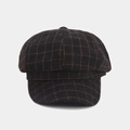 Close-up of brown plaid newsboy cap showing wool texture and octagonal stitching details - Coffee