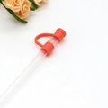 Reusable orange silicone straw cover cap for 8mm to 10mm glass straws on white surface - Deep Pink