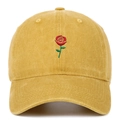Close-up of red rose embroidery and washed cotton texture on mustard yellow baseball cap - Yellow