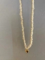 Baroque freshwater pearl necklace featuring a polished golden heart-shaped pendant charm - Heart Fine Rice Pearl