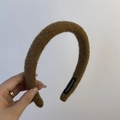 Detail of brown fuzzy textured headband featuring a black handmade woven tag - Woolen Headband / Brown Coffee
