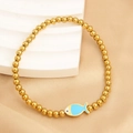 Elastic gold bead bracelet featuring a bright blue fish-shaped charm and polished finish - Blue Fish (NS09-7)