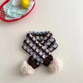 Flat lay of brown and blue houndstooth knitted kids scarf with beige pom-poms on a soft background - Blue, Beige & Coffee Plaid