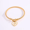 Gold twisted bangle featuring a heart pendant with mother-of-pearl and letter P detail - Letter P