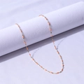 Detail of 18k gold-plated stainless steel chain with orange enamel drop accents - Gold + Orange / 40+5cm