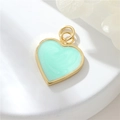 Macro detail of mint green heart pendant with gold frame and marble enamel texture - Mint Green