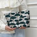 Canvas makeup bag featuring green mushroom print and secure zipper closure - Magic Mushroom Dark Green