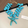 Detailed macro view of the turquoise water drop beads and starfish pendant on the necklace - Necklace / Turquoise Starfish