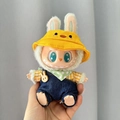 Labubu plush doll in yellow duck hat and blue denim overalls with green polka dot scarf - One-shoulder Duck Baby Carrier Set / First And Second Generation Keychains Are Compatible With La Cloth Dolls. Dolls Not Included.
