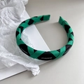 Detail of woven fabric headband in green and black with white CHANGE lettering - Green