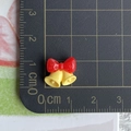 Detailed view of mini Christmas resin bow with bells showing exact 1.5cm size on grid - 06-Bowknot Double Bells