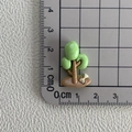 Vue détaillée d'un petit arbre en résine de 2 cm avec os blanc sur papier quadrillé - 12*Planter un arbre