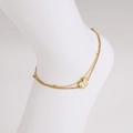 Gold layered butterfly anklet with white shell inlay on a foot mannequin - Anklet
