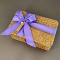 Detailed macro of seagrass woven gift box with a purple ribbon and thank you tag - Purple (DIY Ribbon)
