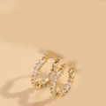 Detail of gold huggie earrings with pave-set square-cut cubic zirconia crystals - Double-sided Zirconia (Gold)