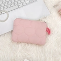 Detailed close-up of pink quilted cosmetic bag with zipper on a soft plush background - Light Pink