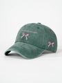 Detail of pink bow embroidery and 'I'm literally just a girl' text on washed green cap - Dark Green