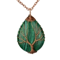 Macro shot of copper wire wrapped tree of life pendant with green malachite stone - Malachite Antique Bronze