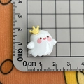 Macro shot of a 2cm cute white resin ghost charm with crown on a measuring ruler - Yellow Crown Ghost / Large