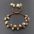 Detail of hand-woven brown cord bracelet with translucent yellow prehnite stones - Citrine