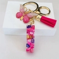 Close-up of golden butterfly charm, pink tassel, and resin rectangle keychain - Rose Red Butterfly Tassel Clip / Letter I