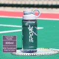 Detail of 800ml purple sports water bottle with tea infuser on a tennis court - 800ML / Purple