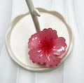 Pink transparent resin flower hair claw clip displayed on a white ceramic jewelry dish - Red (Rolled Flower)