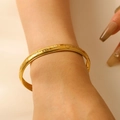 Golden stainless steel cuff bracelet featuring embossed evil eye patterns for women - Eye Relief Bracelet (3244)