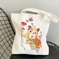 White canvas tote bag featuring a cute hamster and floral illustration over a chair - C10 Floral Hamster
