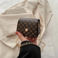 Brown mini square bag with gold chain strap and clover pattern in a handheld view - Clover Coffee