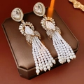 Detail of vintage champagne gold tassel earrings with pearls and crystal bow accents - Long Tassel Bow Knot Style / Gold White