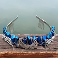 Silver crystal crown with blue rainbow stones and crescent moon on wooden railing - Dark Blue