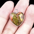 Polished green and orange heart-shaped stone pendant with silver metal frame - Unakite Silver Edging
