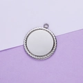 Close-up of a silver stainless steel round pendant with detailed rope edge and mirror finish - Steel Color (25MM)