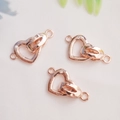Macro detail of three rose gold heart shaped jewelry connectors for DIY necklaces - Heart Clasp Rose Gold