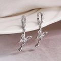 Silver butterfly drop earrings with heart zircon stones shown on a white ceramic vase - Silver Heart Wings (45159)