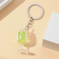 Detail of green miniature drink keychain with fake lemon slices and striped straw - Green