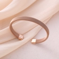 Detail view of rose gold woven mesh bangle featuring polished square metal end caps - Rose Gold
