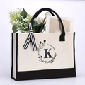 Beige canvas tote bag with black handles, floral letter K print and Summer Vibe text - Letter-K
