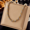 Two-tone gold and silver braided twist chain necklace on a beige display stand - Gold Silver Braided Chain (N1786)