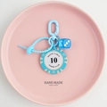 Detail of blue Monte Carlo poker chip and dice keychain on a pink pastel tray - Blue Beige-10 Value