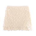 Detailed view of oversized champagne paillettes on an elegant mini sequin skirt - XS / Off White