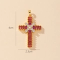 Detailed close-up of gold cross pendant with red and clear gemstones and size dimensions - Style K-Red Rectangular Zirconia Cross