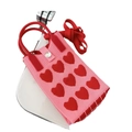 Detail of pink knitted phone bag with red hearts, shoulder strap and silver button - Heart Red